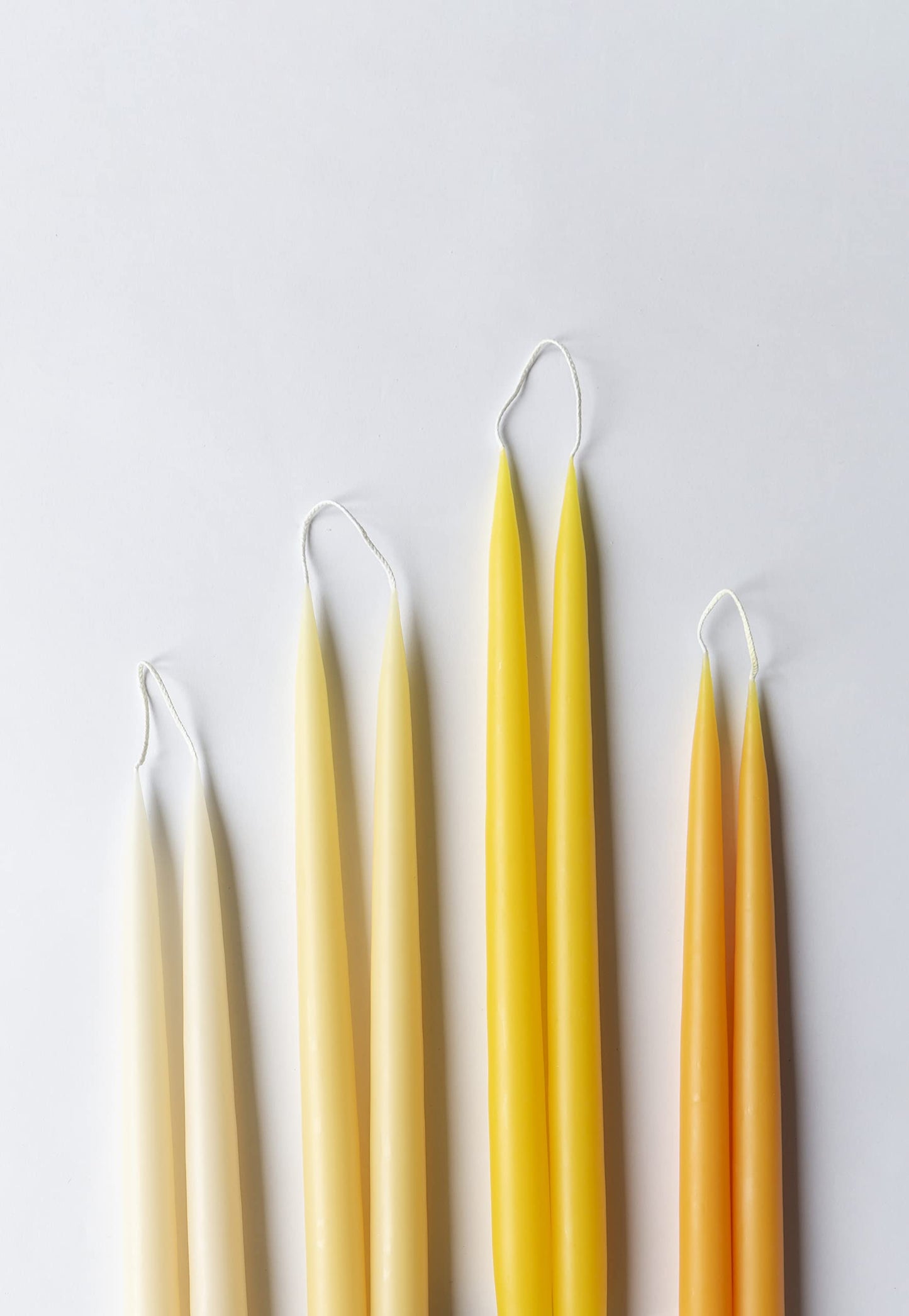 Kunstindustrien® Taper Candles, Set of 4, 13.8" – Made in Denmark, Long Burning Candles 15h, Unscented & Smokeless Candlesticks – Elegant Tall Candles for Weddings Dinners & Home Decor (Pastel Yellow)
